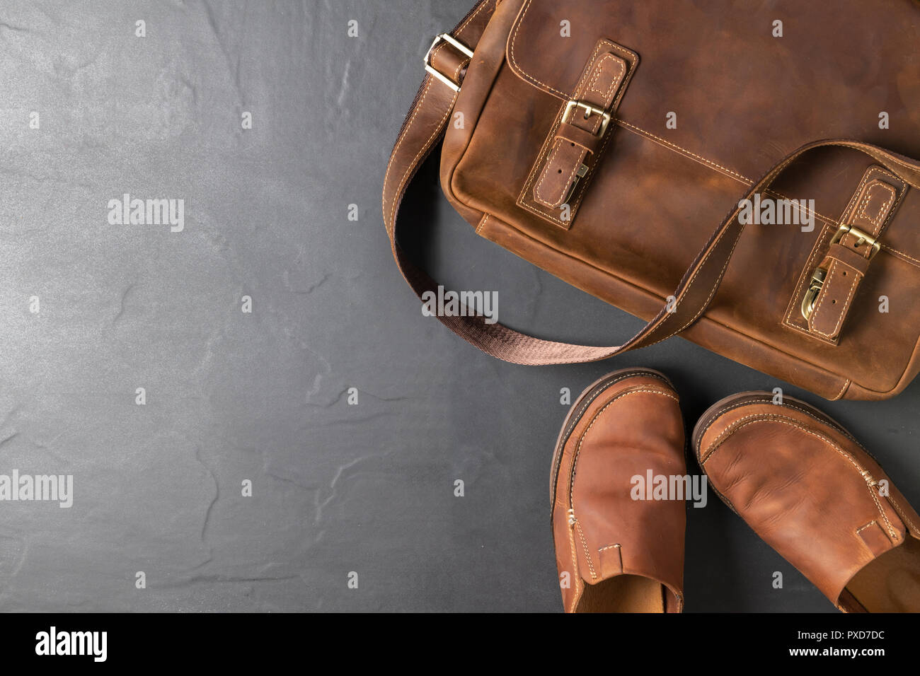 Leather Vintage bag and leatrher Casual Shoes on black stone background with copy space, accessories costume concept Stock Photo