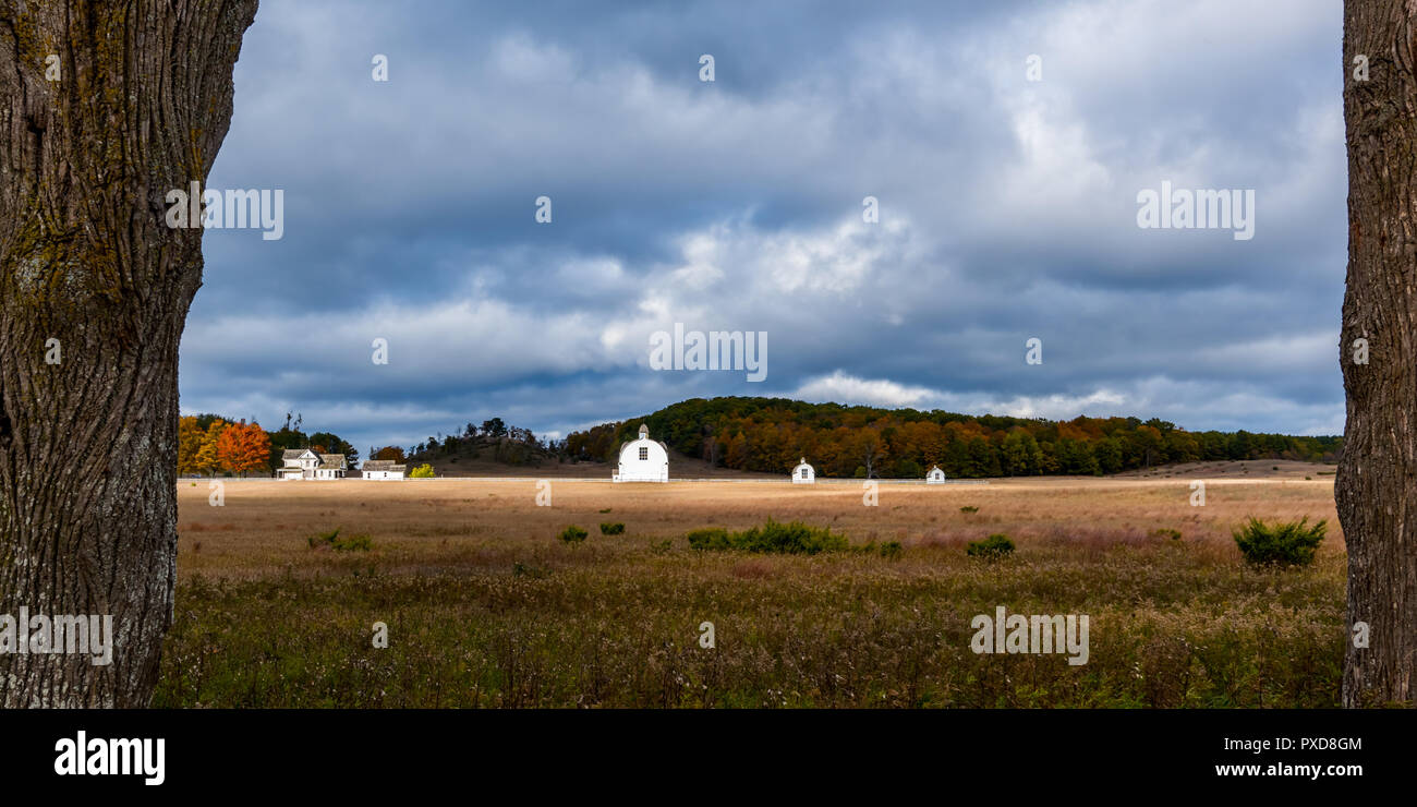 19th century white farm buildings on the historic The D.H. Day Farm with dramatic autumn skies. Sleeping Bear Dunes National Lakeshore, Michigan, USA. Stock Photo