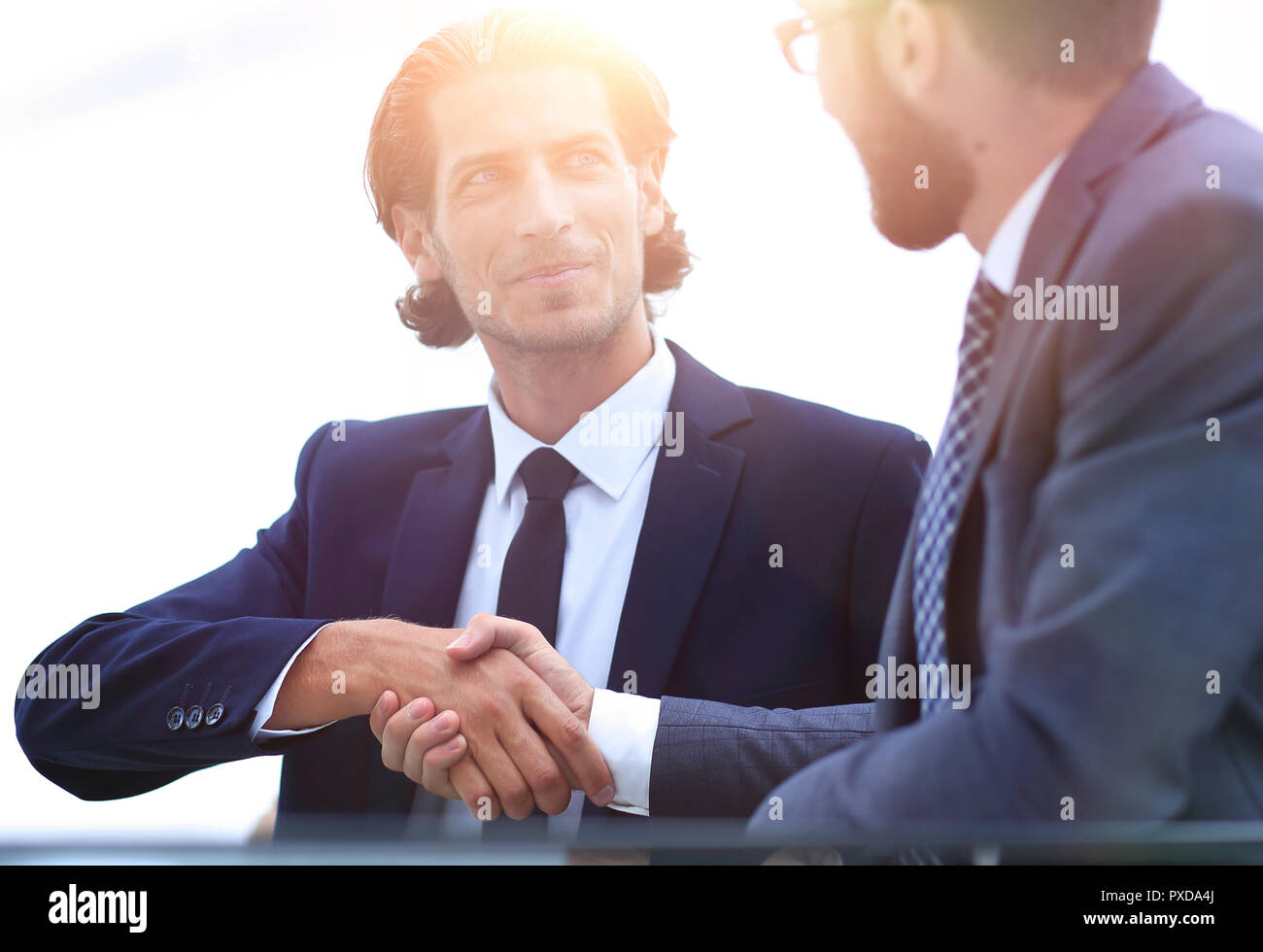confident handshake colleagues in the office Stock Photo - Alamy