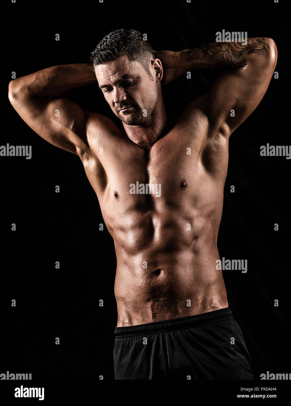 Male showing toned body after fitness workout at gym Stock Photo