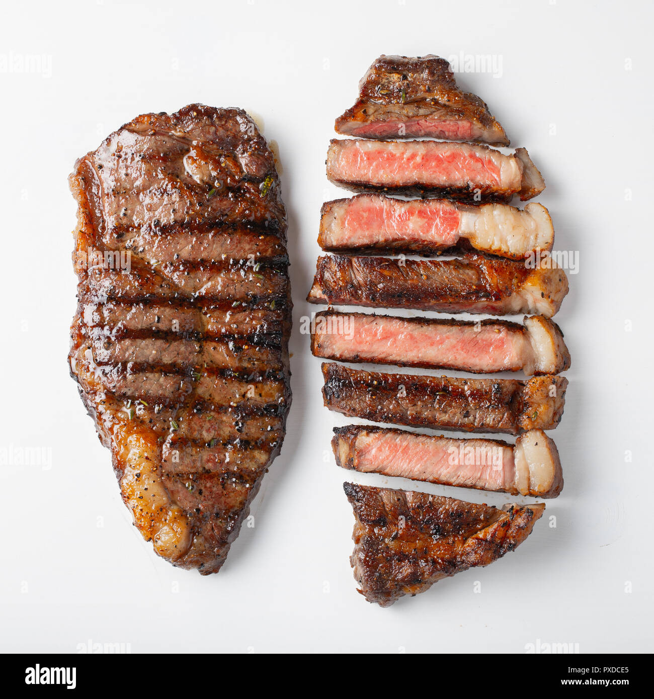 Two grilled marbled beef steaks striploin isolated on white background, top  view Stock Photo - Alamy