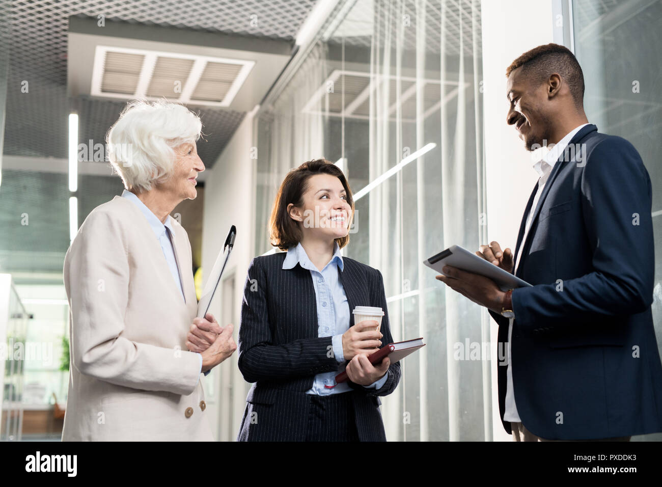 Positive business colleagues discussing company development Stock Photo