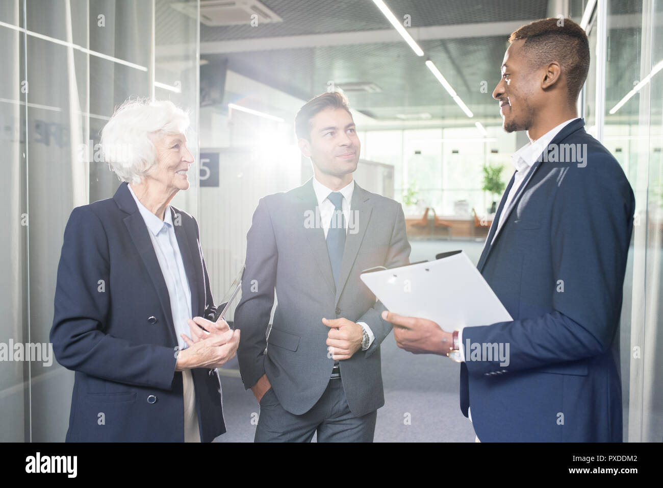 Content business colleagues communicating in office Stock Photo