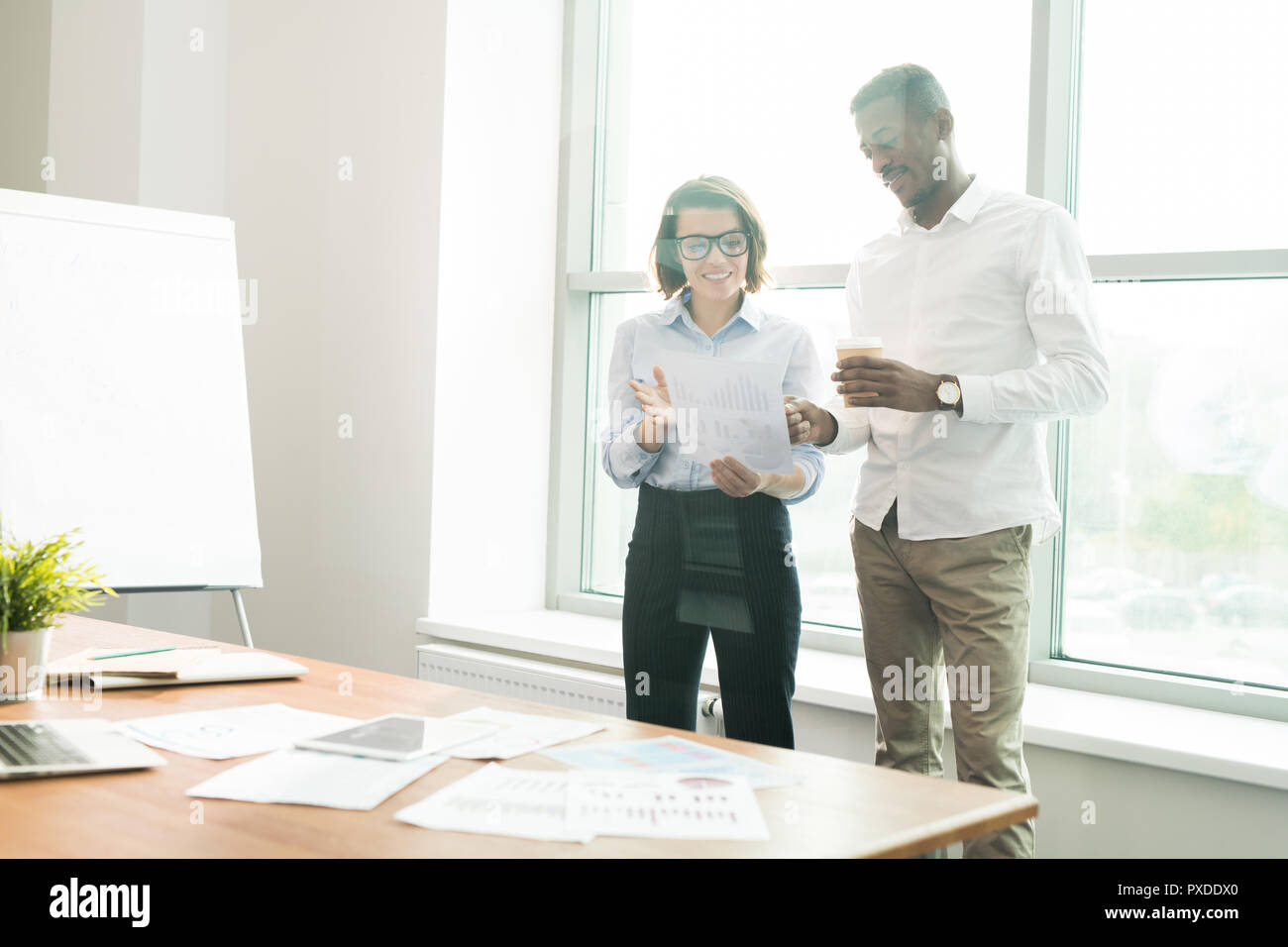 Confident analysts viewing data in board room Stock Photo