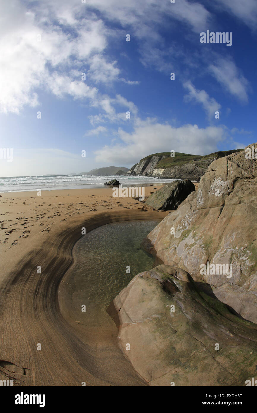 snady beach with narrow water holeunder cliff face, wild atlantic way, county kerry, ireland Stock Photo