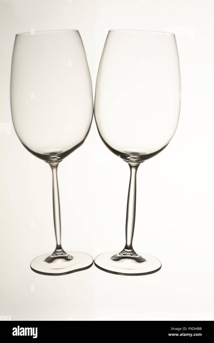 Two empty glass cups lying horizontally. Stock Photo