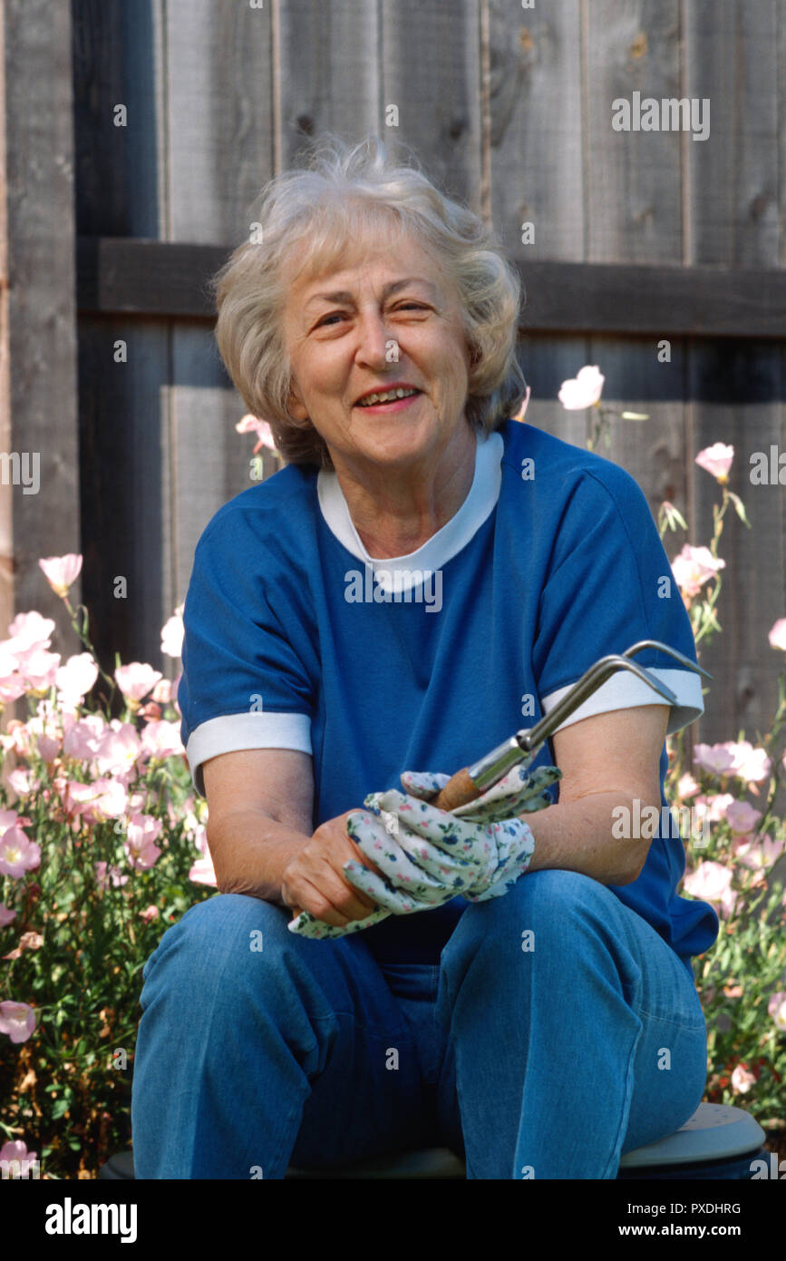 Senior woman enjoys working in her garden, USA Stock Photo - Alamy