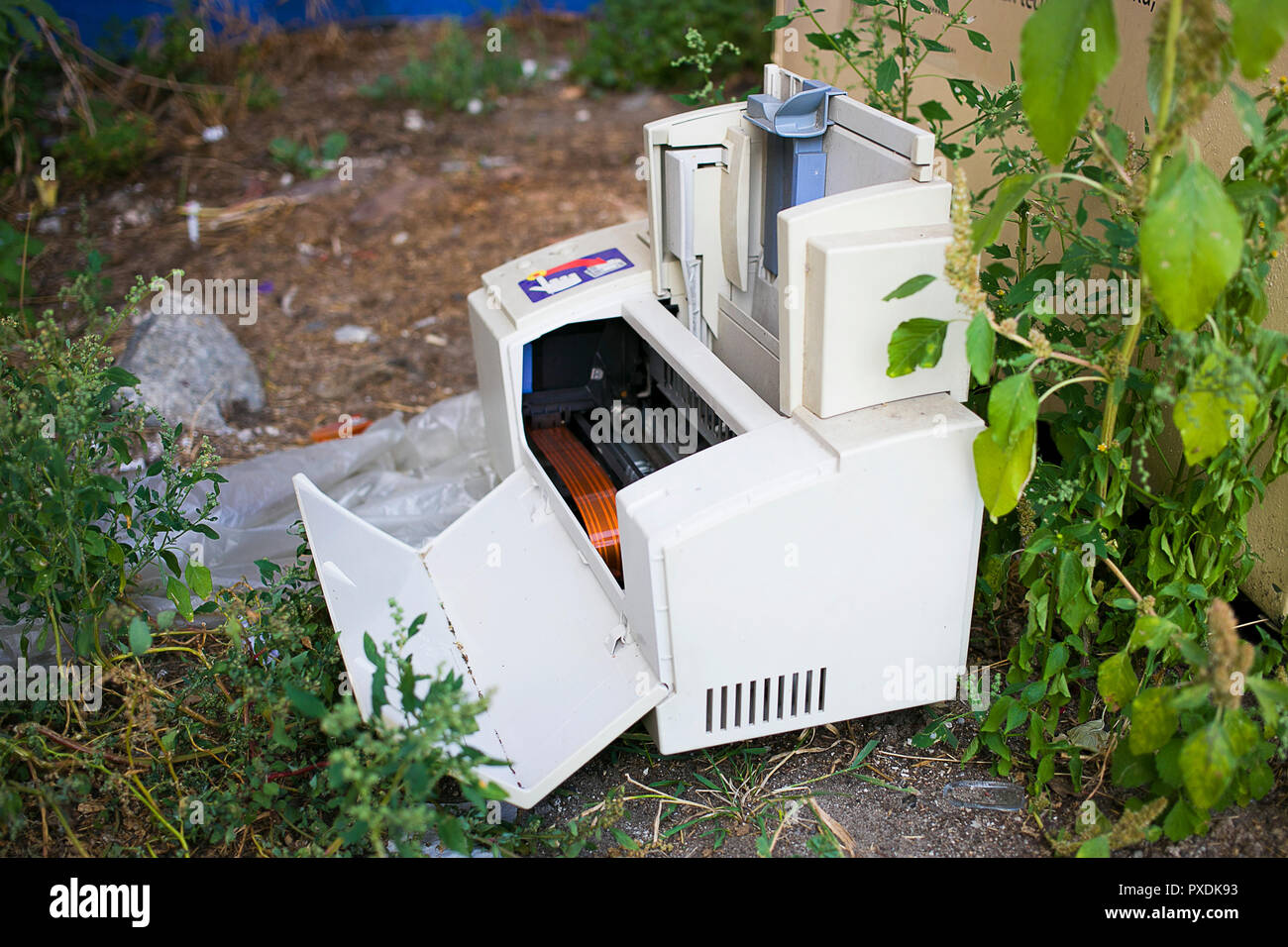white broken printer left on the corner of the street as electronic trash Stock Photo