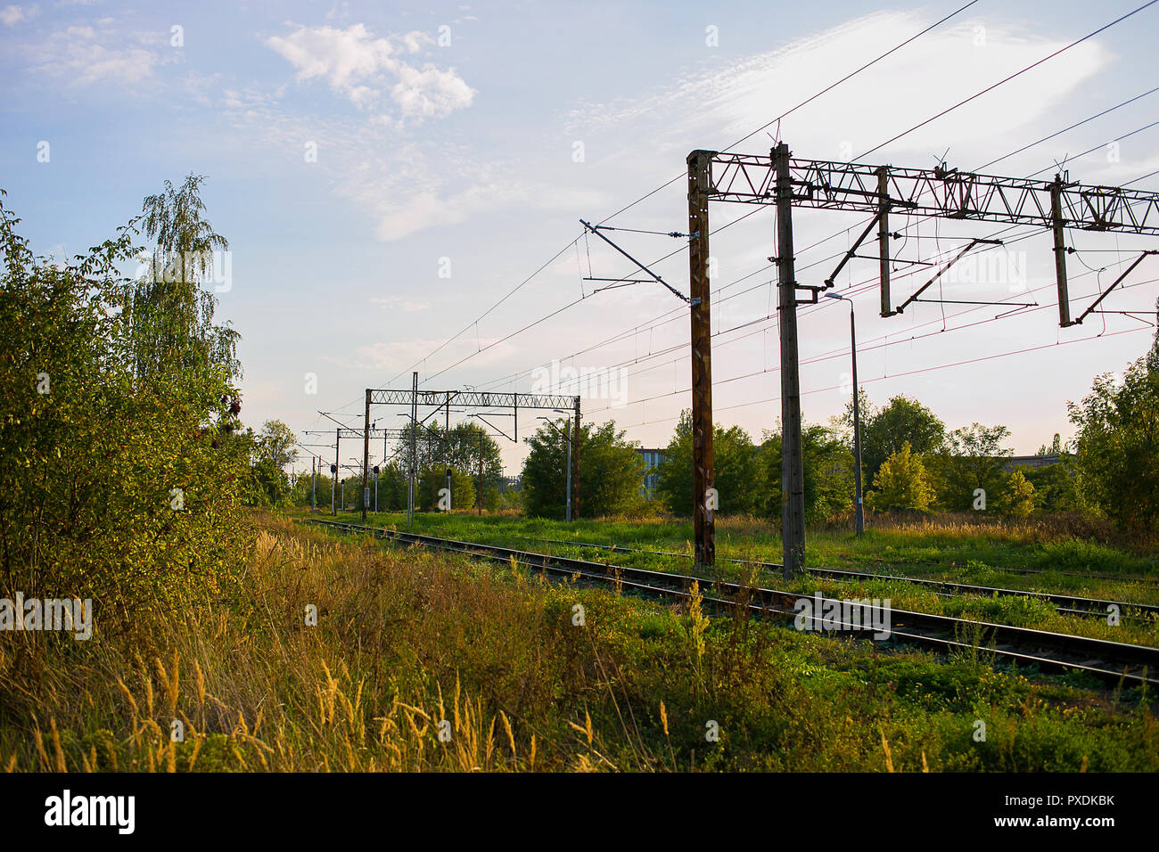 Train track with electricity lines above for ecological transportation