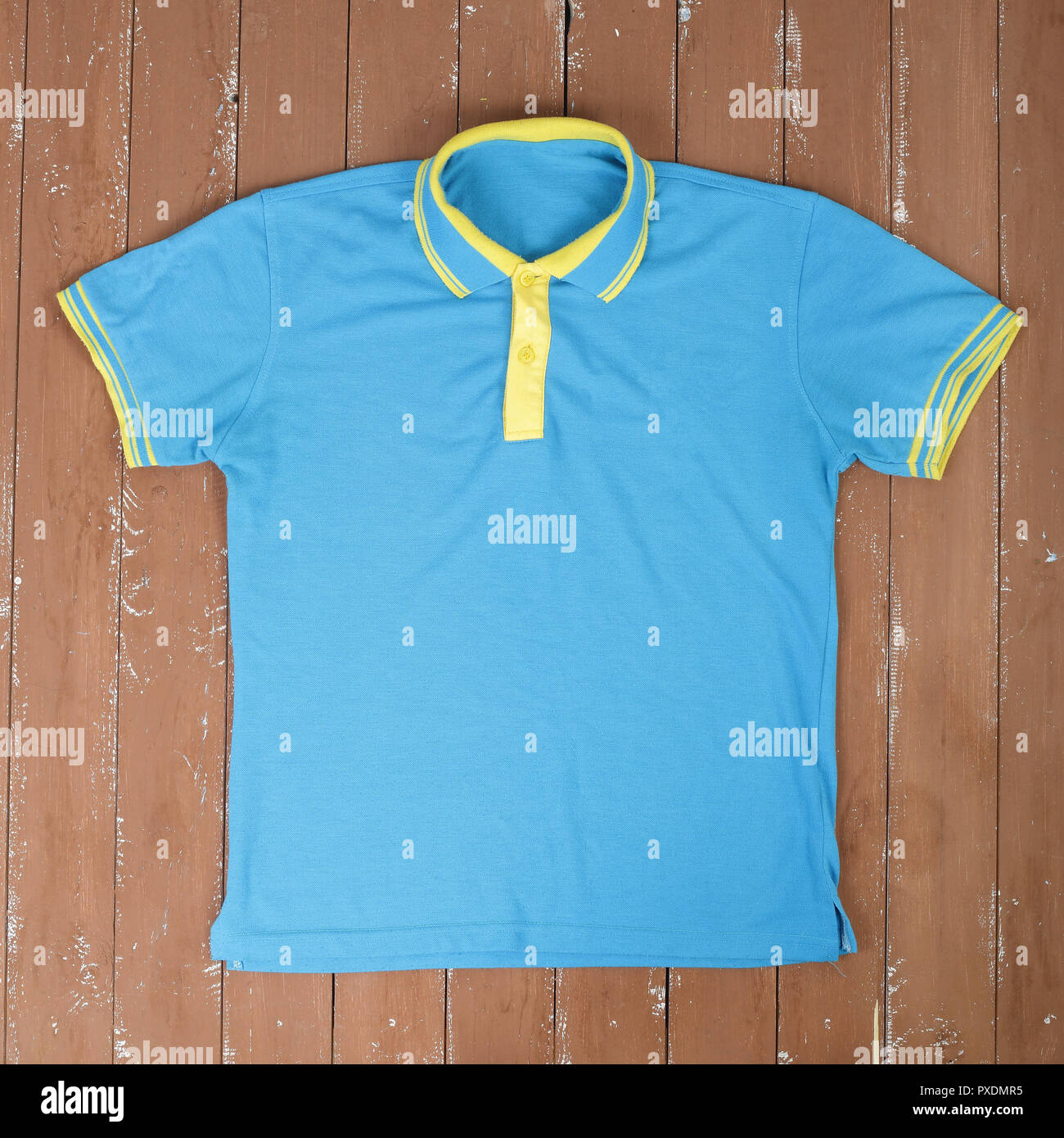Clothes, shoes and accessories - Closeup blue and yellow Polo shirt on a  wooden background Stock Photo - Alamy