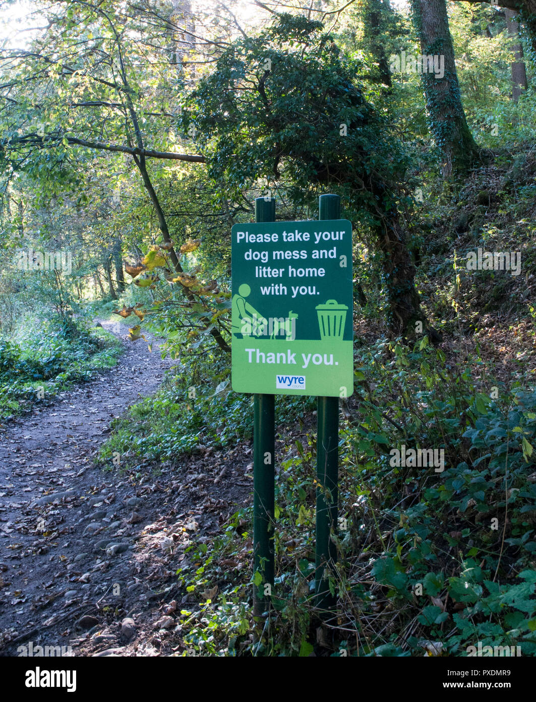 Polite notice notice to take dog mess and litter home from Brock Valley Nature walk with people on path . Brock Mill Preston Lancashire England UK Stock Photo