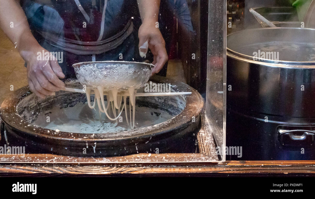making Chinese noodles in the Asian market Stock Photo Alamy