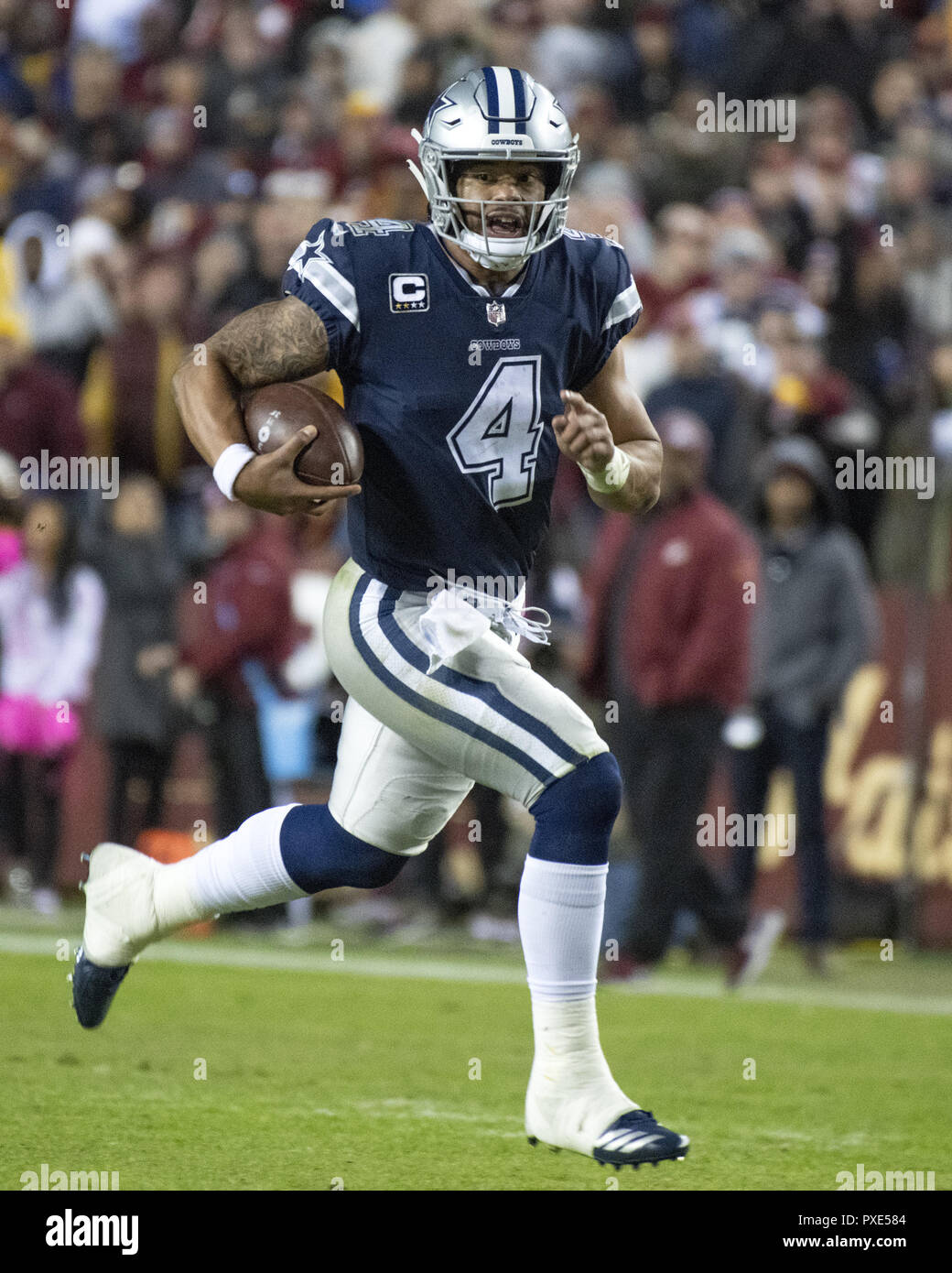 Landover, Maryland, USA. 21st Oct, 2018. Dallas Cowboys quarterback Dak Prescott (4) scrambles for a first down late in the fourth quarter against the Washington Redskins at FedEx Field in Landover, Maryland on Sunday, October 21, 2018. The Redskins won the game 20 - 17 Credit: Ron Sachs/CNP/ZUMA Wire/Alamy Live News Stock Photo