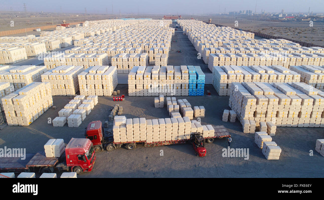 (181022) -- BEIJING, Oct. 22, 2018 (Xinhua) -- Workers load ginned cotton into a truck in Tiemenguan, northwest China's Xinjiang Uygur Autonomous Region, Nov. 30, 2017. About 106 thousand tons of ginned cotton would be transported to other province from here. China's road freight transport continued fast expansion in the first nine months of 2018, the Ministry of Transport said in a statement Oct. 20, 2018. From January to September, the amount of cargo carried on roads, which takes up the lion's share in China's total cargo transport, increased 7.5 percent year on year to 28.64 billion tonnes Stock Photo