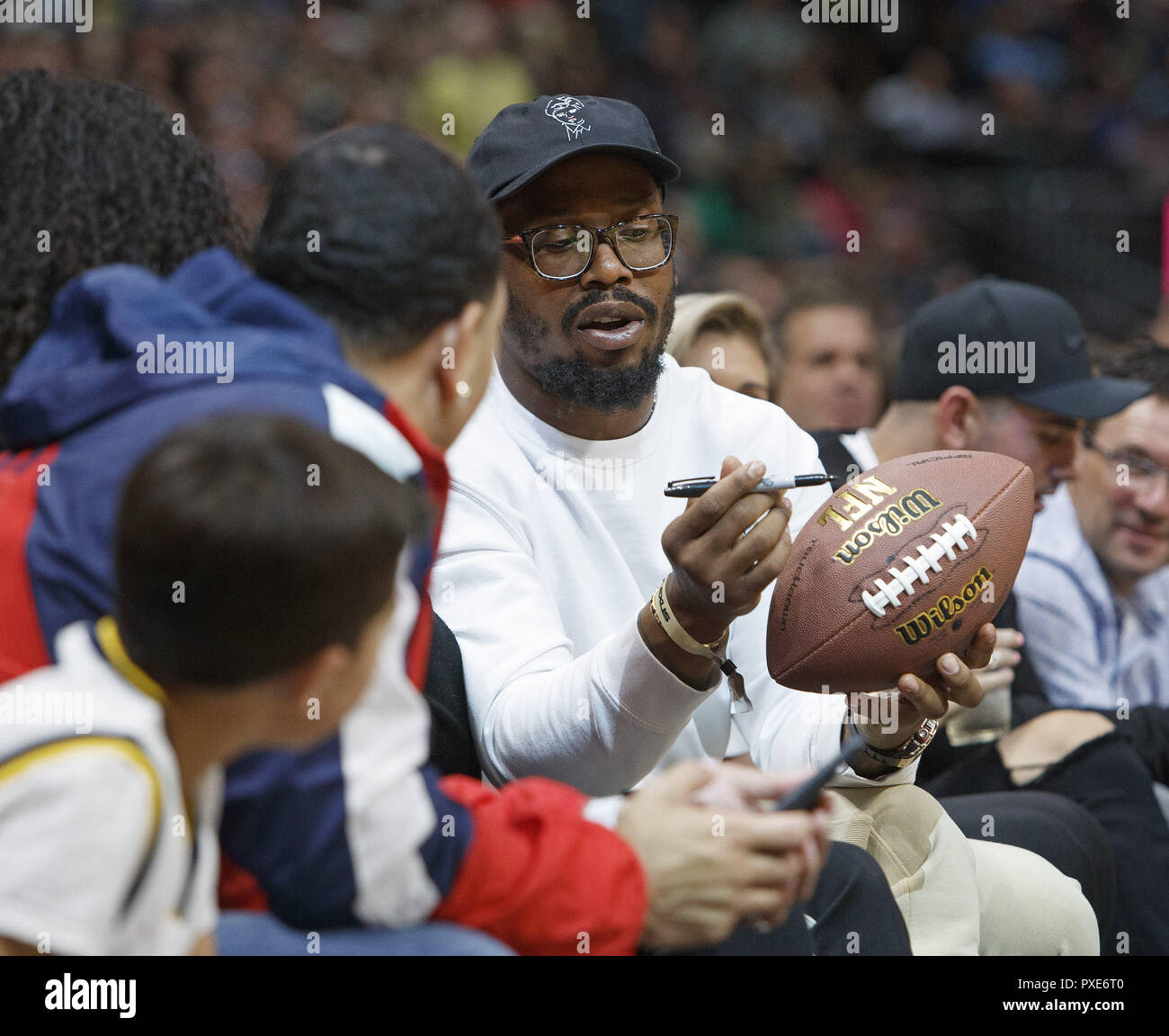 Denver, Colorado, USA. 21st Oct, 2018. Denver Broncos OLB VON MILLER, signs a football with team mates for Rocky the mascot to throw into the stands during the 2nd. Half at the Pepsi Center Sunday night. The Nuggets beat the Warriors 100-98. Credit: Hector Acevedo/ZUMA Wire/Alamy Live News Stock Photo