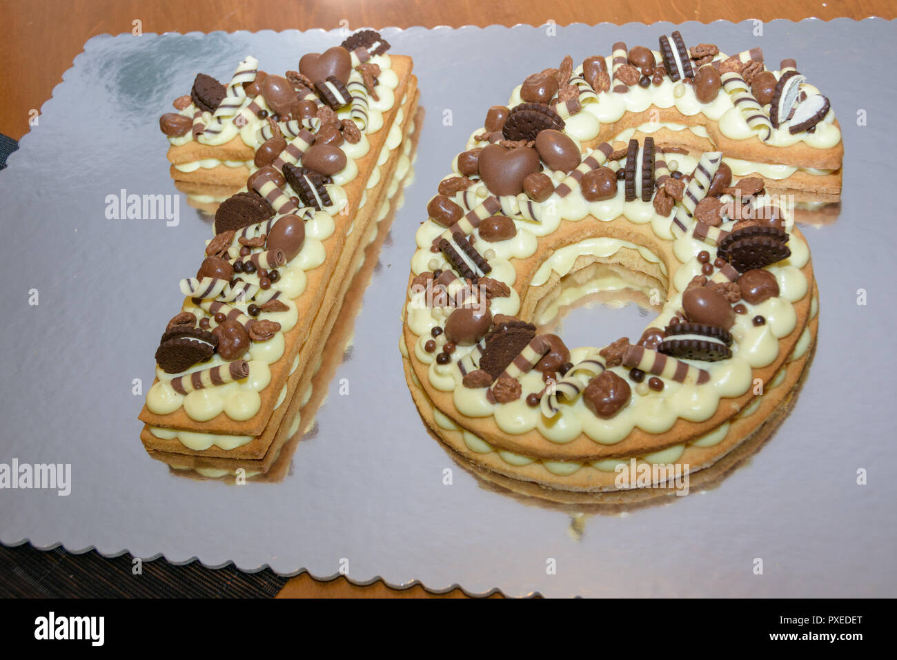 Original Sweet Sixteen birthday cake decorated with chocolate candies Stock Photo