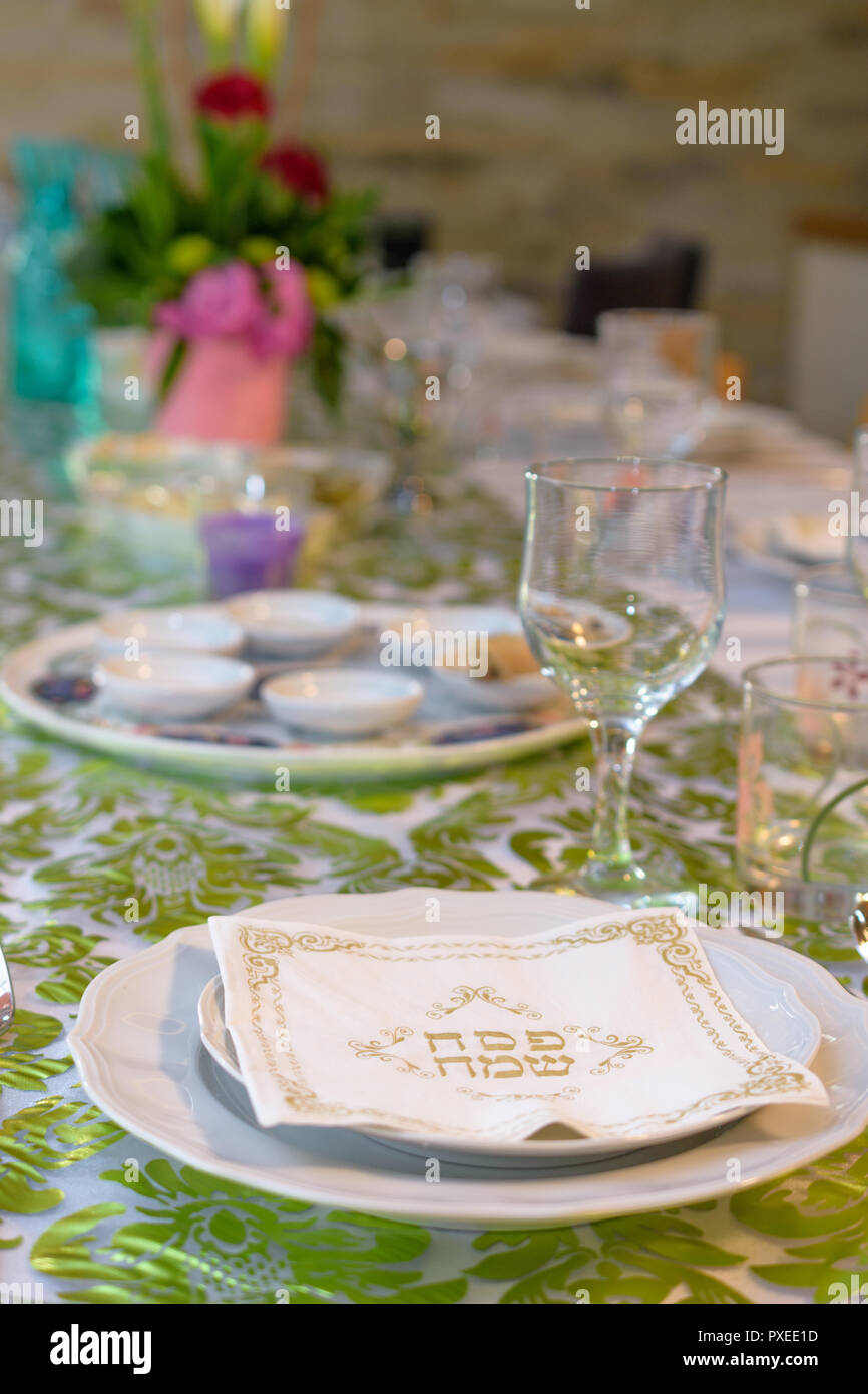 Modern Passover Seder table with green and gold decorations in Tel Aviv