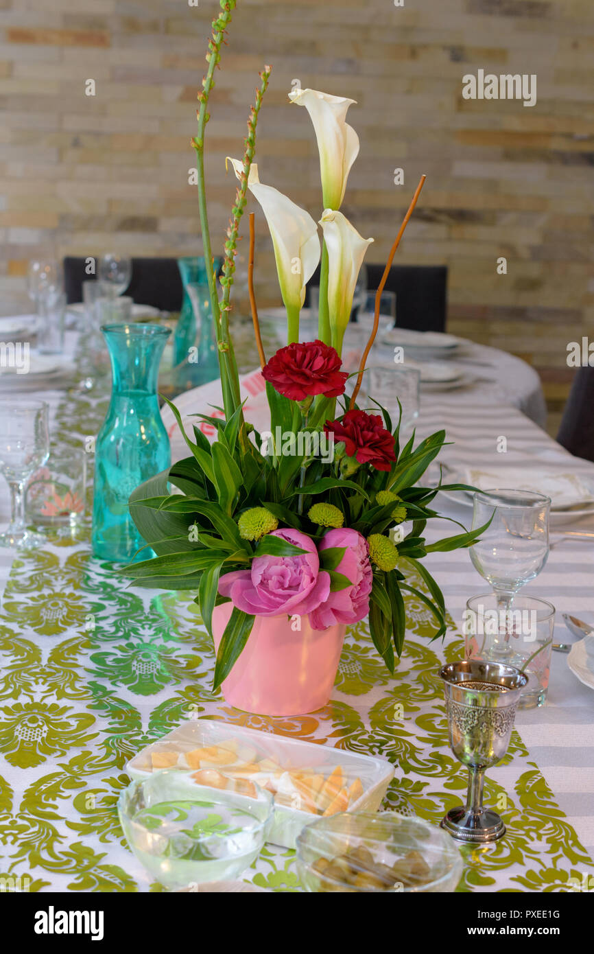 Modern Passover Seder table with green and gold decorations in Tel Aviv