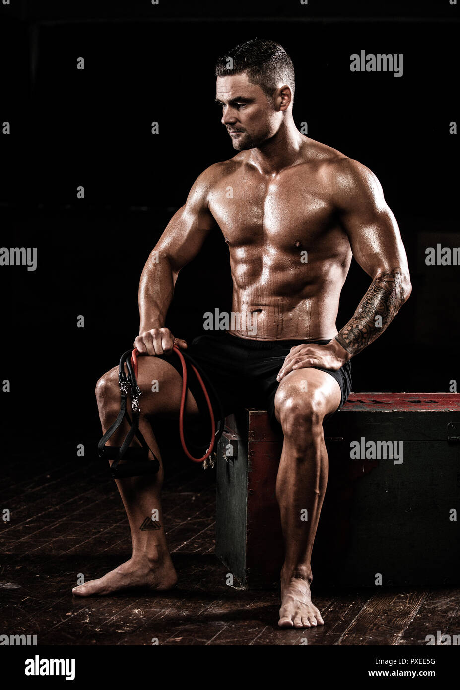 Male sitting after using resistance bands after training exercise Stock Photo