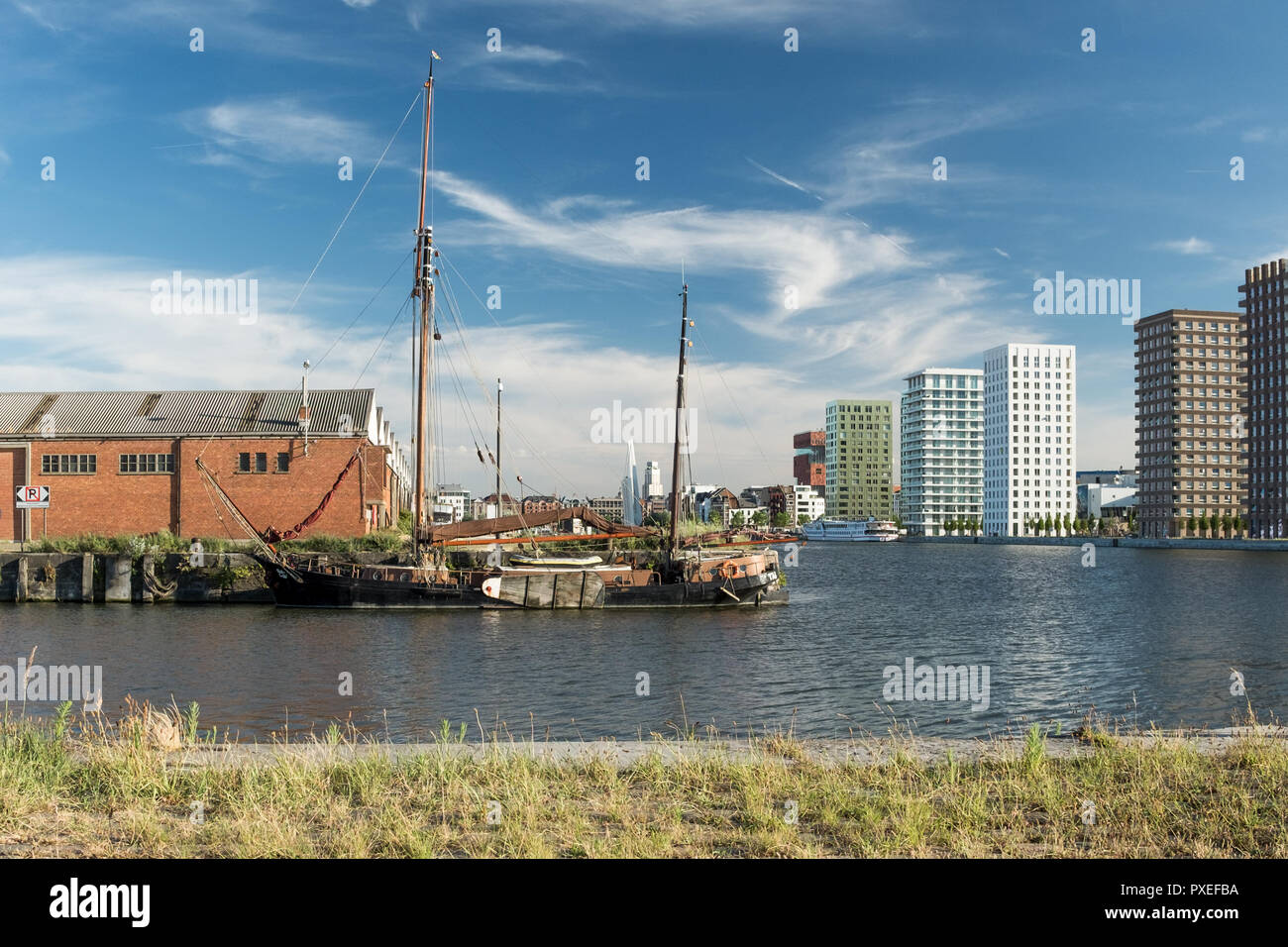 Old boat and buildings in Northern part of Antwerp, Monday 25 June 2017, Antwerp, Belgium. Stock Photo