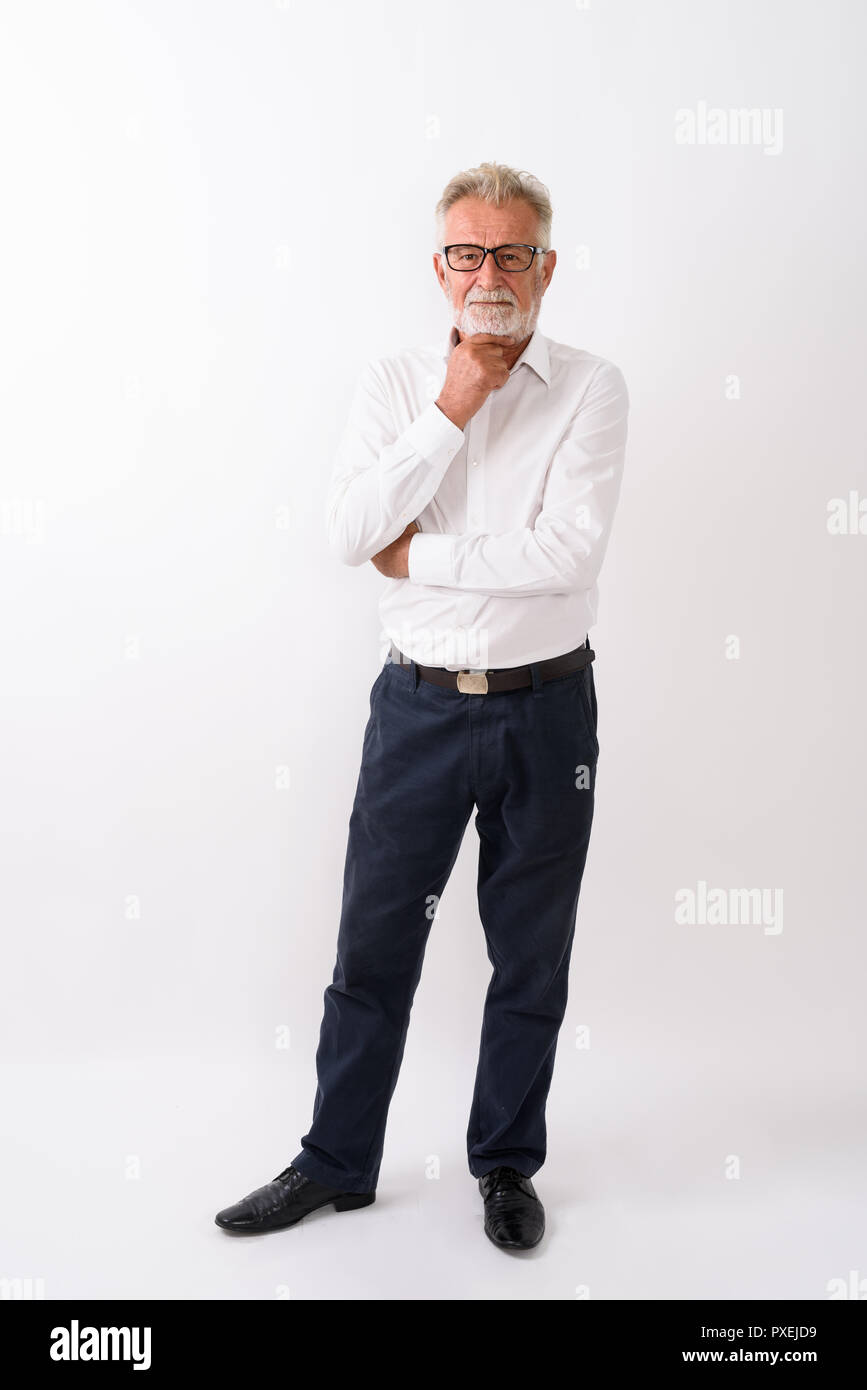 Full body shot of handsome senior bearded man standing while thi Stock Photo