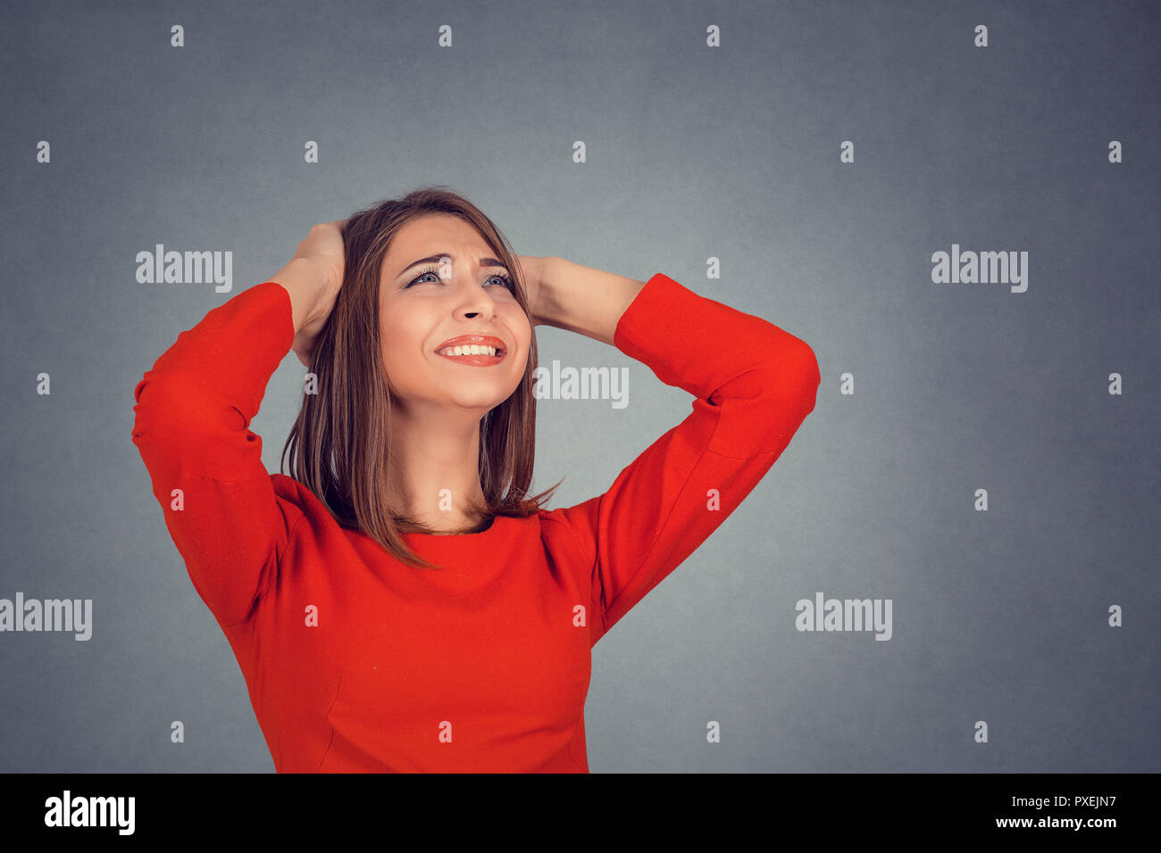 angry woman covering ears looking up stop loud noise Stock Photo Alamy