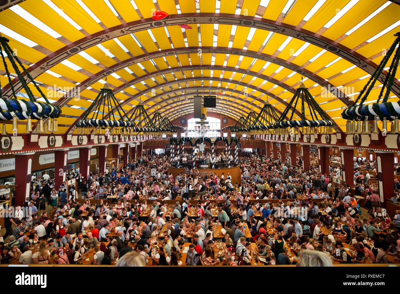 Crowd of people in Lowenbrau tent in Munich city, Germany Stock Photo