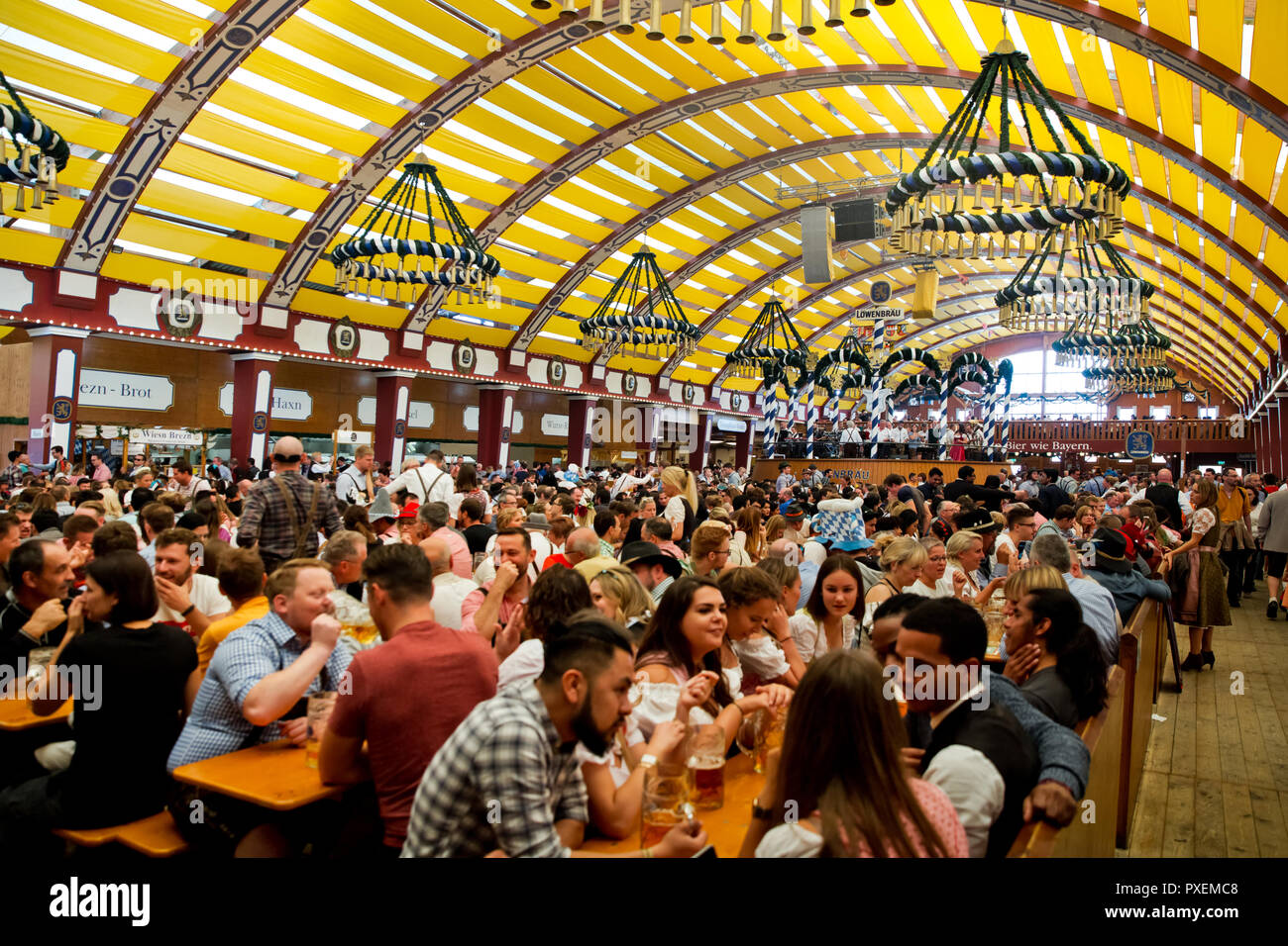 Crowd of people in Lowenbrau tent in Munich city, Germany Stock Photo