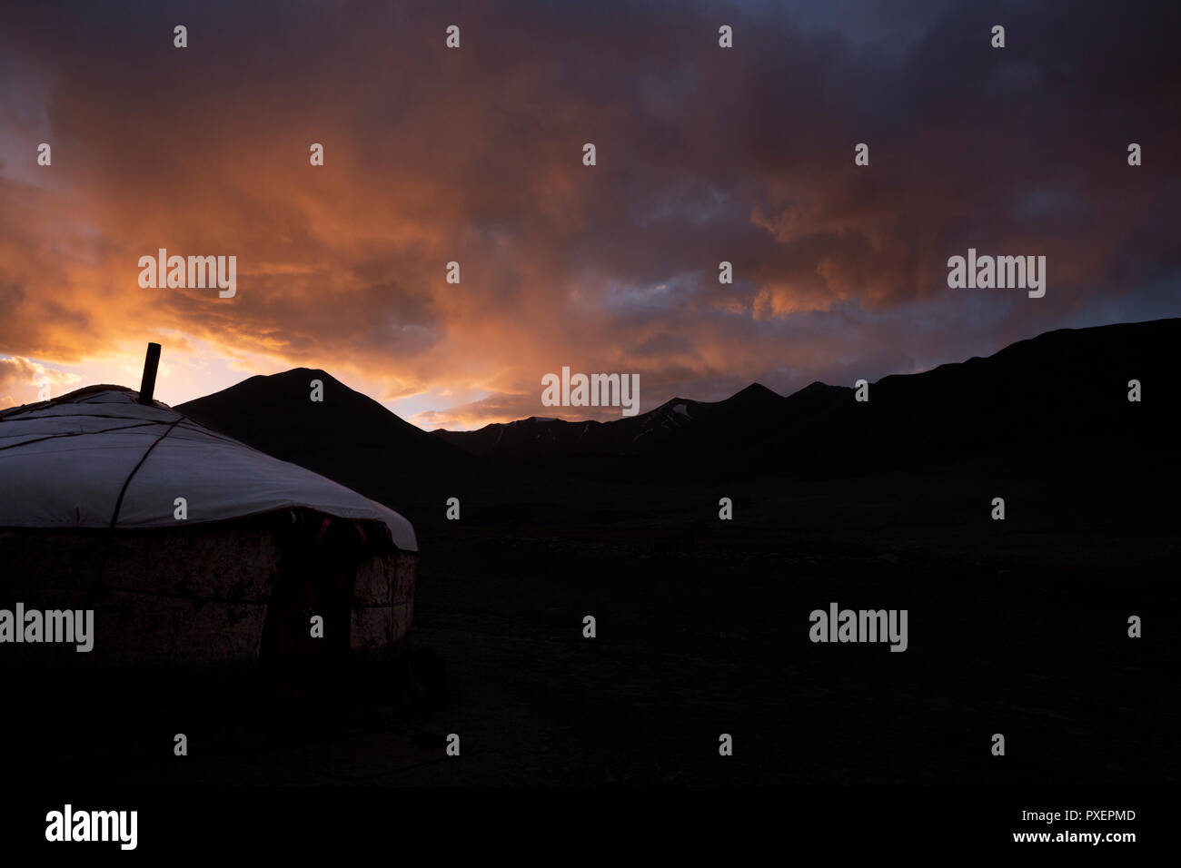 Kyrgyz yurt silhouetted in sunset, Kara Jilga, Pamir Mountains, Gorno Badakhshan Autonomous Region, Tajikistan Stock Photo