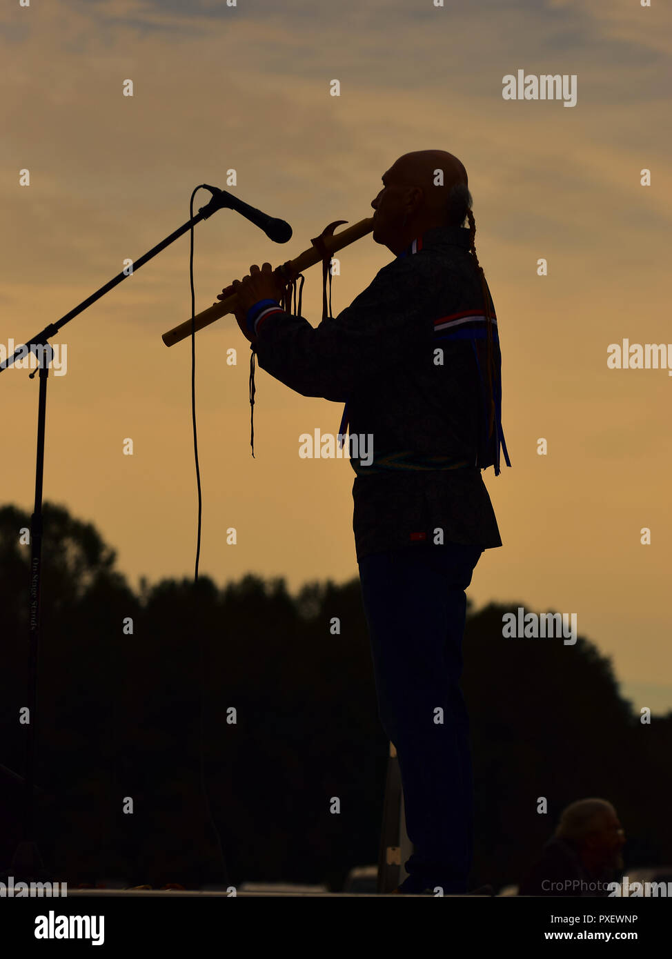 Silhouette of Native American play flute at sunset Stock Photo