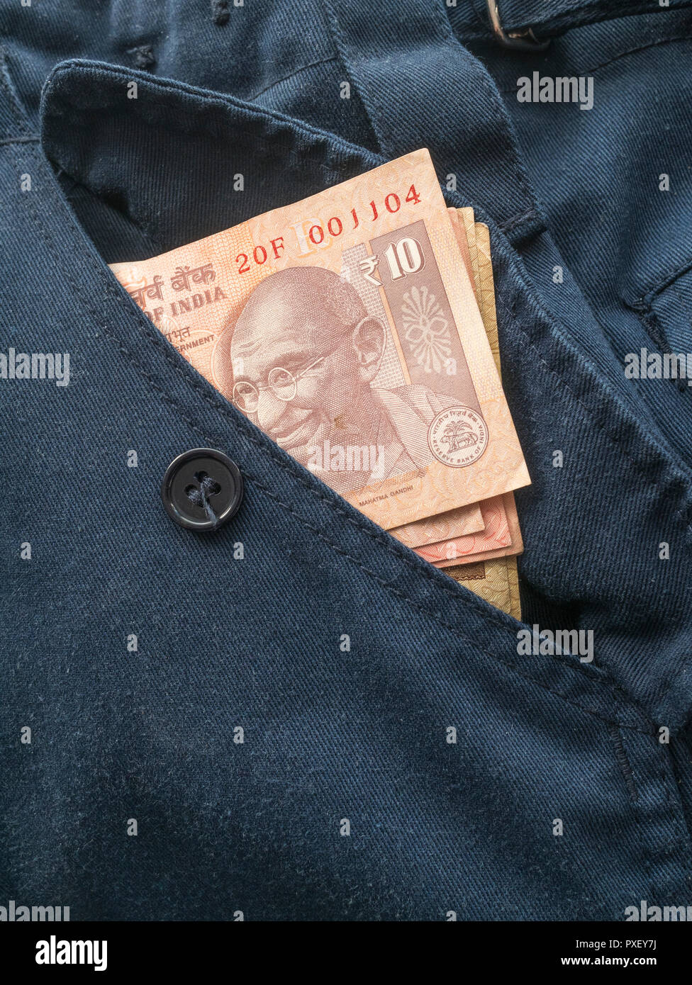 Indian 10 Rupee banknote in pocket. Metaphor personal earnings, Indian wages levels, India economy, India rupee currency, BRICS, India interest rate. Stock Photo