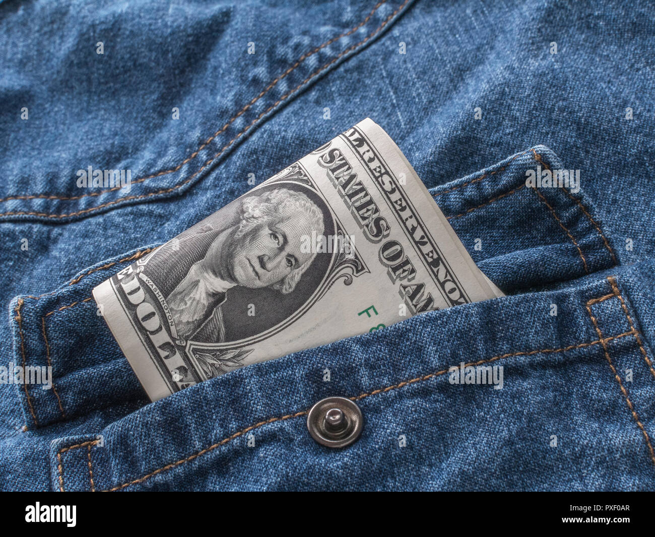 US / American 1 Dollar bills in pocket - metaphor for 'Money in Your Pocket', U.S. earnings, Biden economy. US banking crisis metaphor. Stock Photo