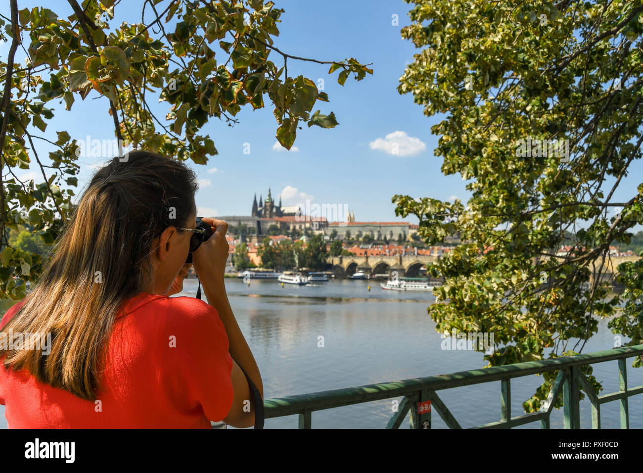PRAGUE, CZECH REPUBLIC - SPETEMBER 2018: Tourist taking a picture of the River Vltava and city skyline in Prague. Stock Photo