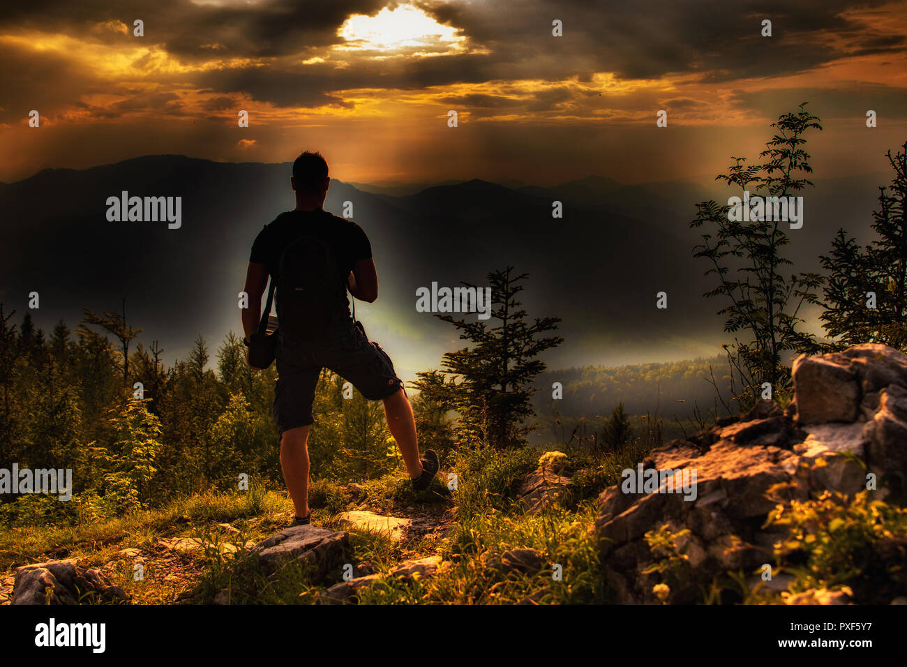 A man at the top of the mountain during the sunset Stock Photo - Alamy