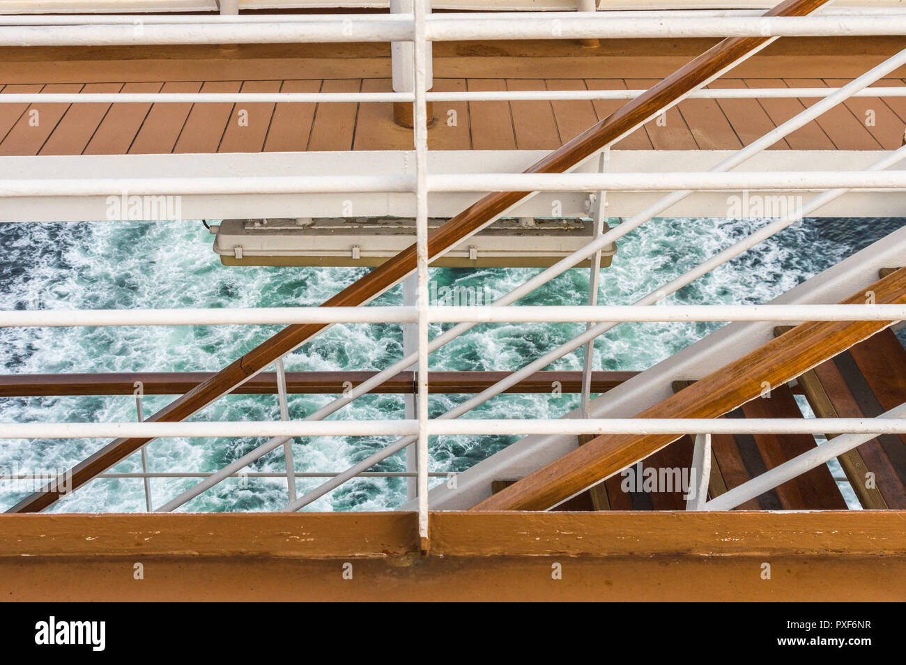 Graphic image of exterior access stairway, decks and ship's wake, stern of cruise ship, Inside Passage, British Columbia, Canada. Stock Photo