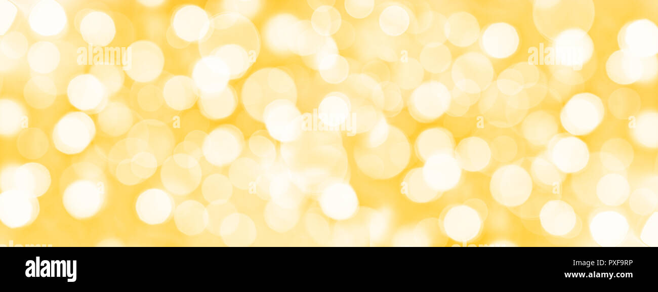 Holiday golden panoramic background with blurred bokeh lights Stock Photo
