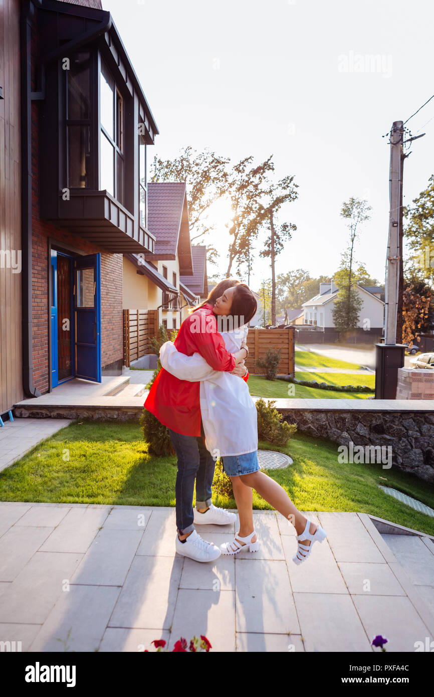 Delighted nice Asian woman hugging her boyfriend Stock Photo - Alamy