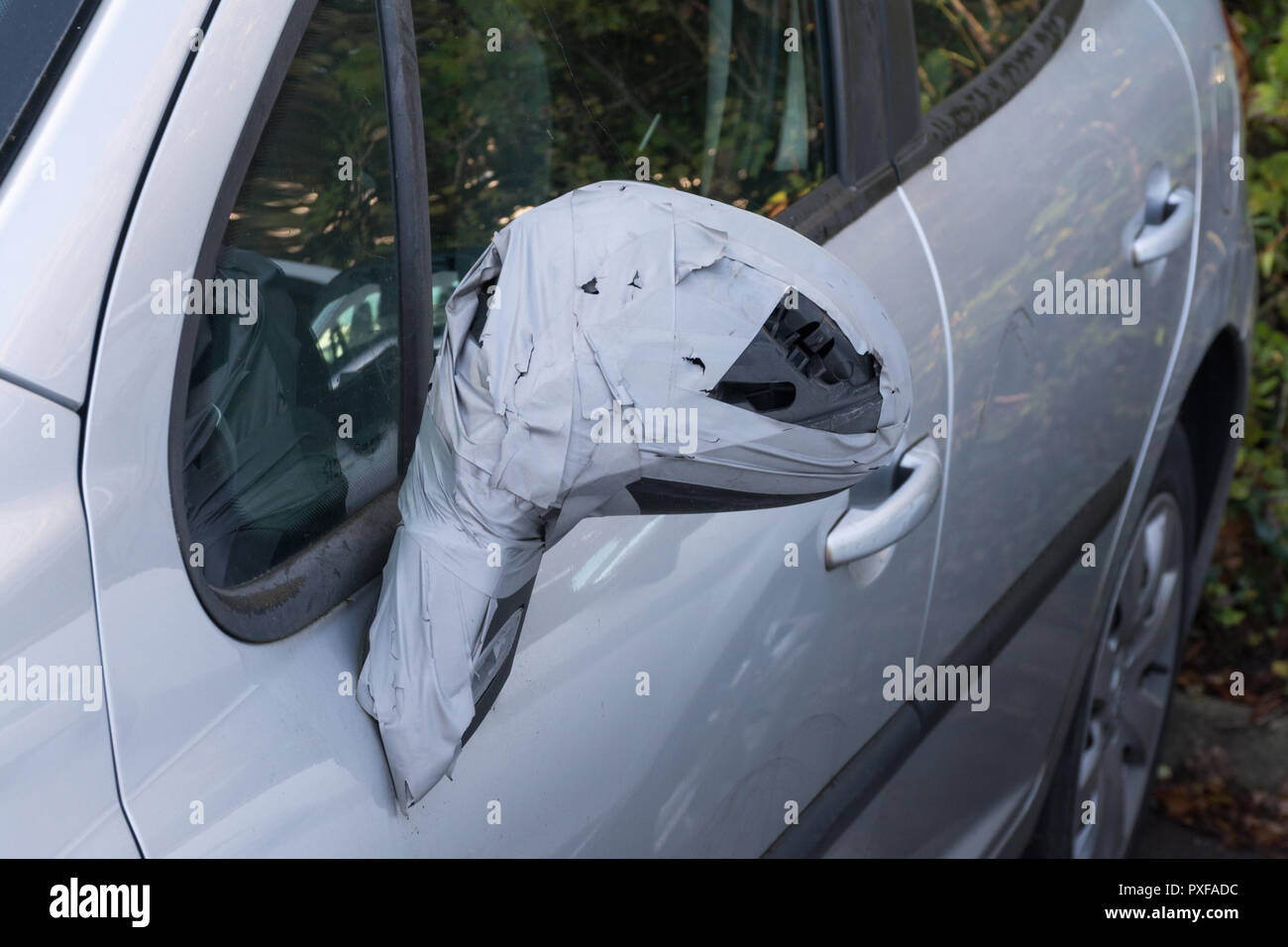 Damaged car wing mirror repaired using sticky tape Stock Photo
