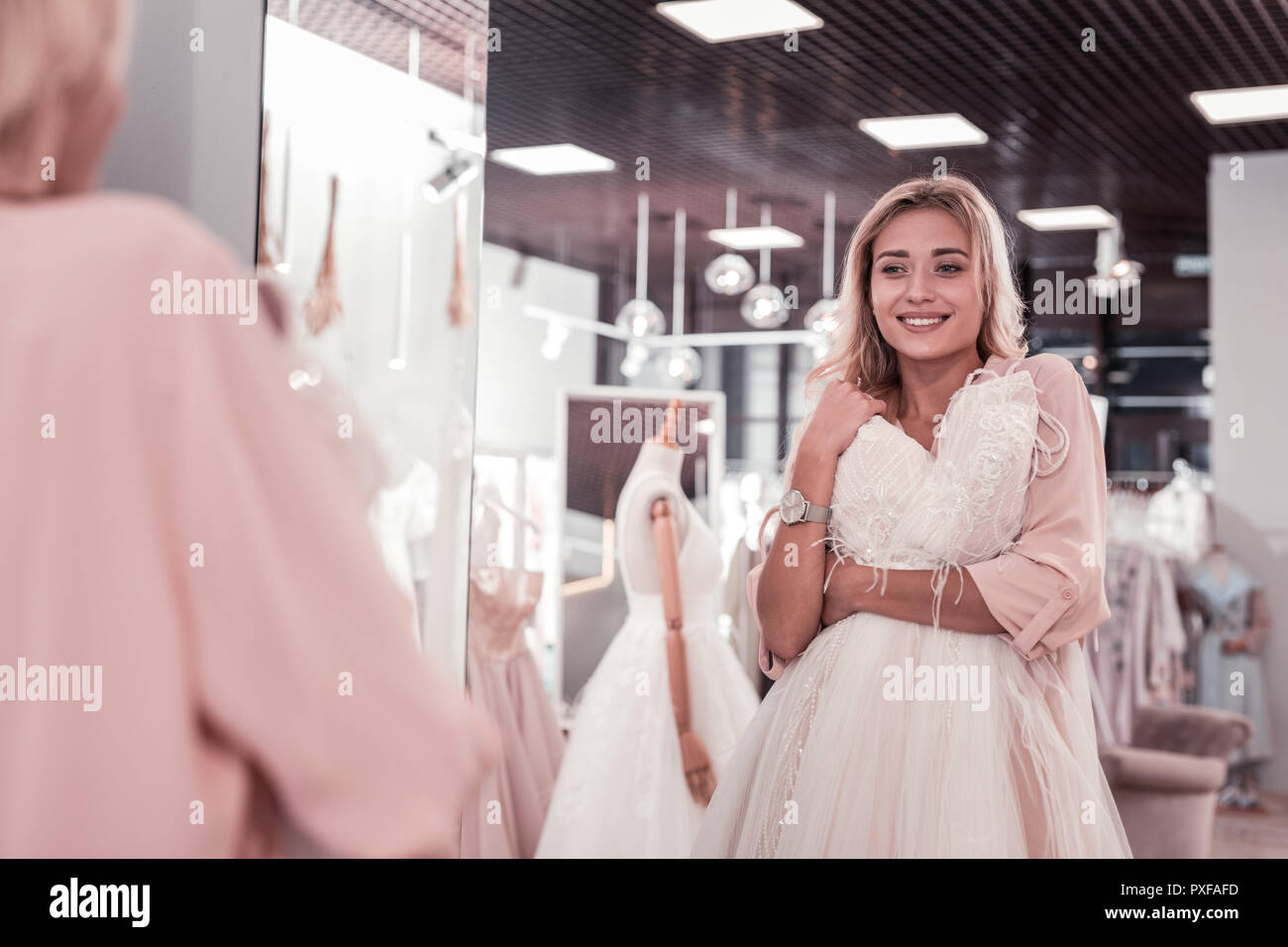 Nice young woman looking at her reflection Stock Photo