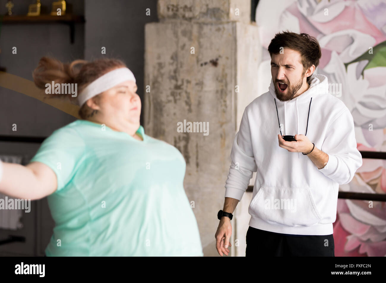 Angry Coach Training Obese Woman Stock Photo