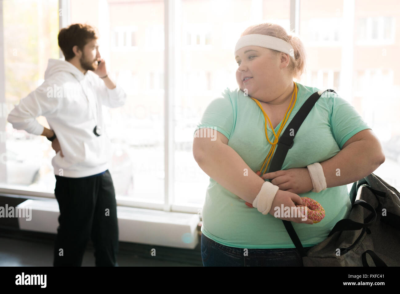 Obese Woman Hiding Food Stock Photo