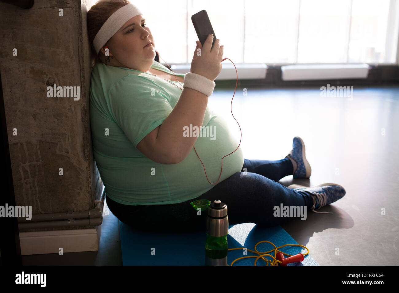 Getting Fat Problem Phone Fat Woman Using Smartphone after Workout Stock Photo - Alamy