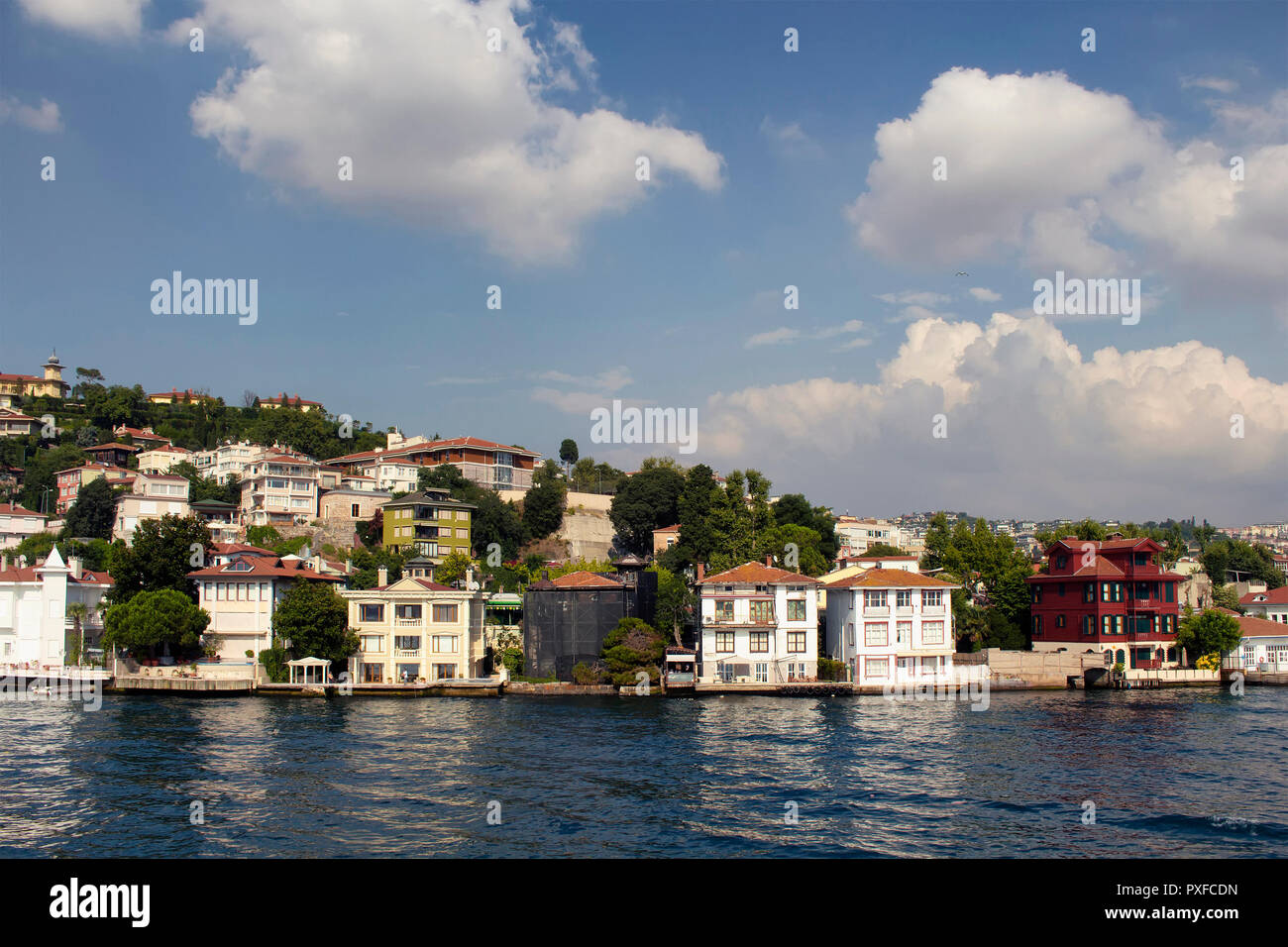 View of historical, old Turkish / Ottoman houses by Bosphorus on Asian side of Istanbul. It is a sunny summer day. Stock Photo