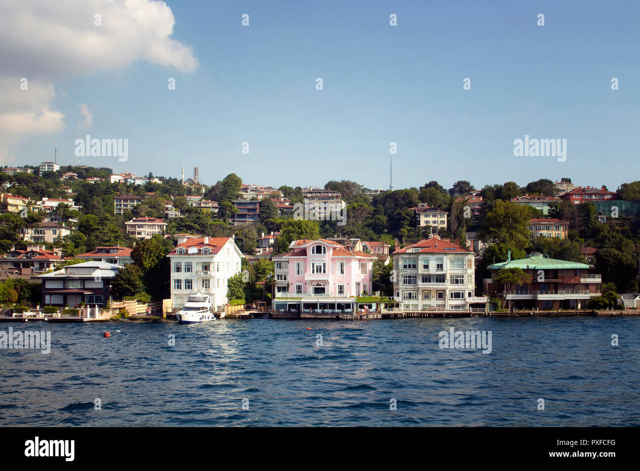 View of houses and buildings by Bosphorus on the Asian side of Istanbul. It is a sunny summer day. Stock Photo