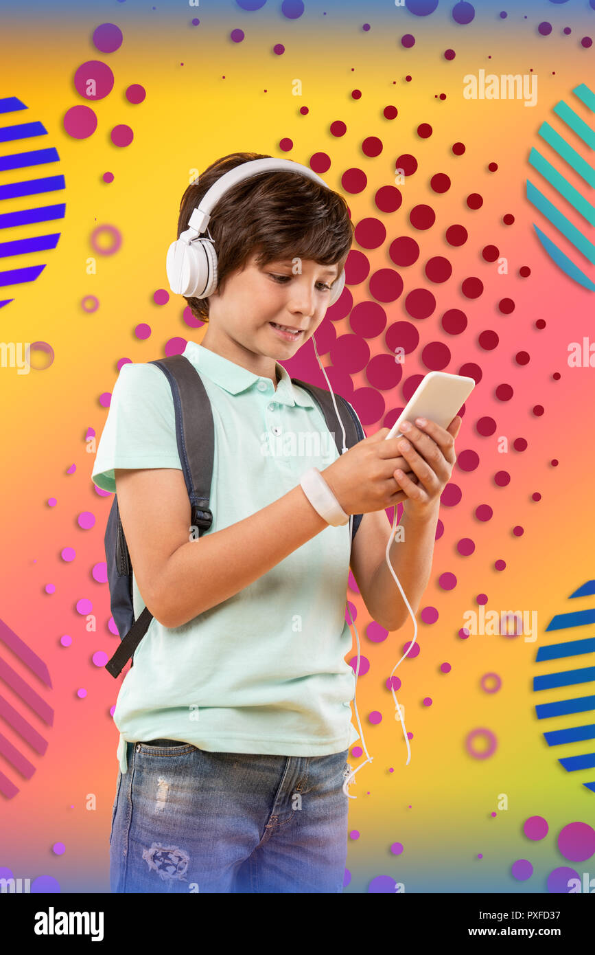 Focused attractive boy choosing music on background Stock Photo