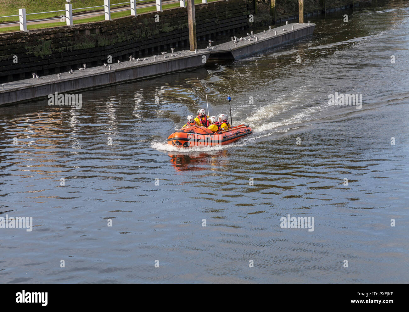 RNLI lifeboat crew on a training exercise in a dinghy at Teddington