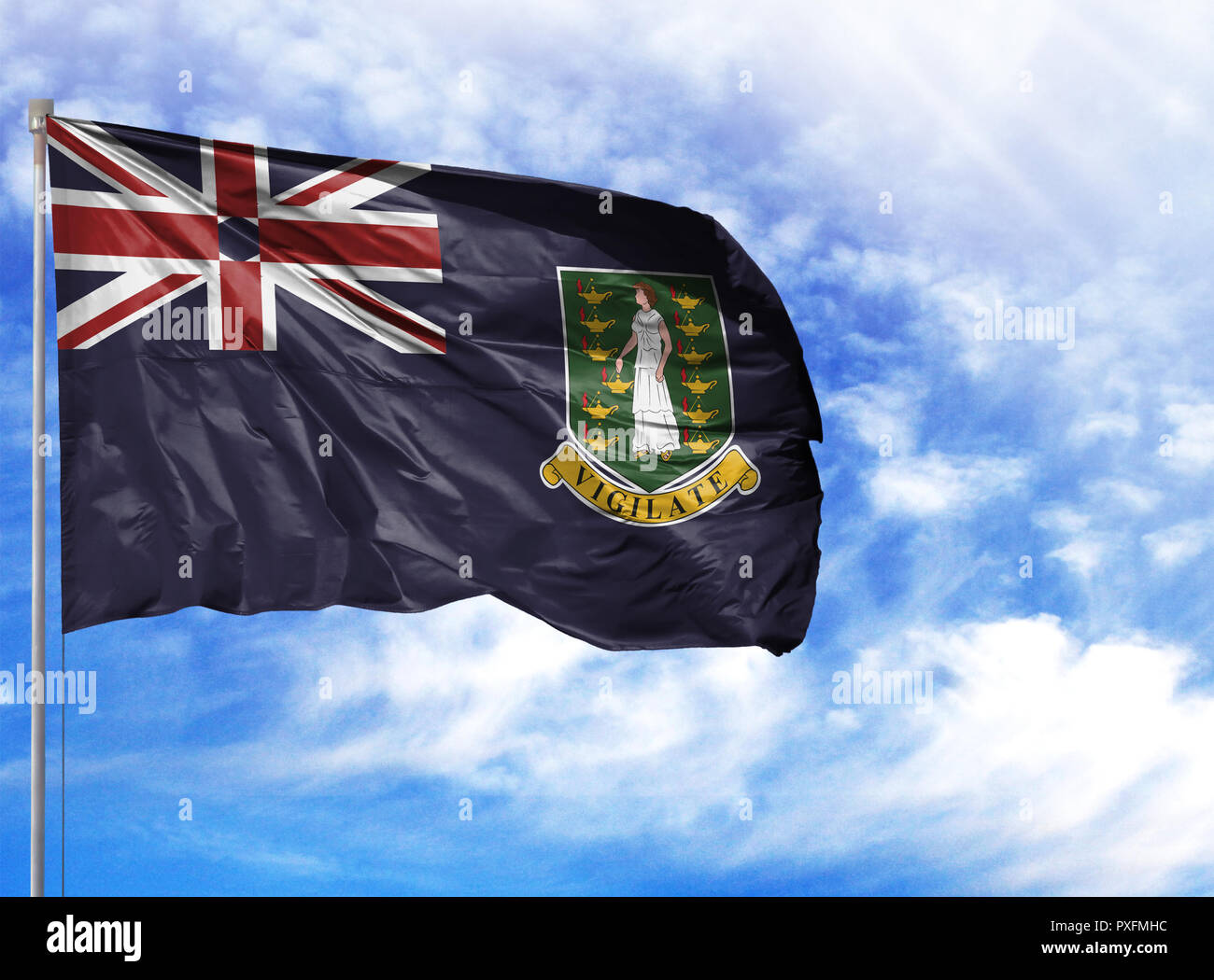 National flag of British Virgin Islands on a flagpole in front of blue sky. Stock Photo