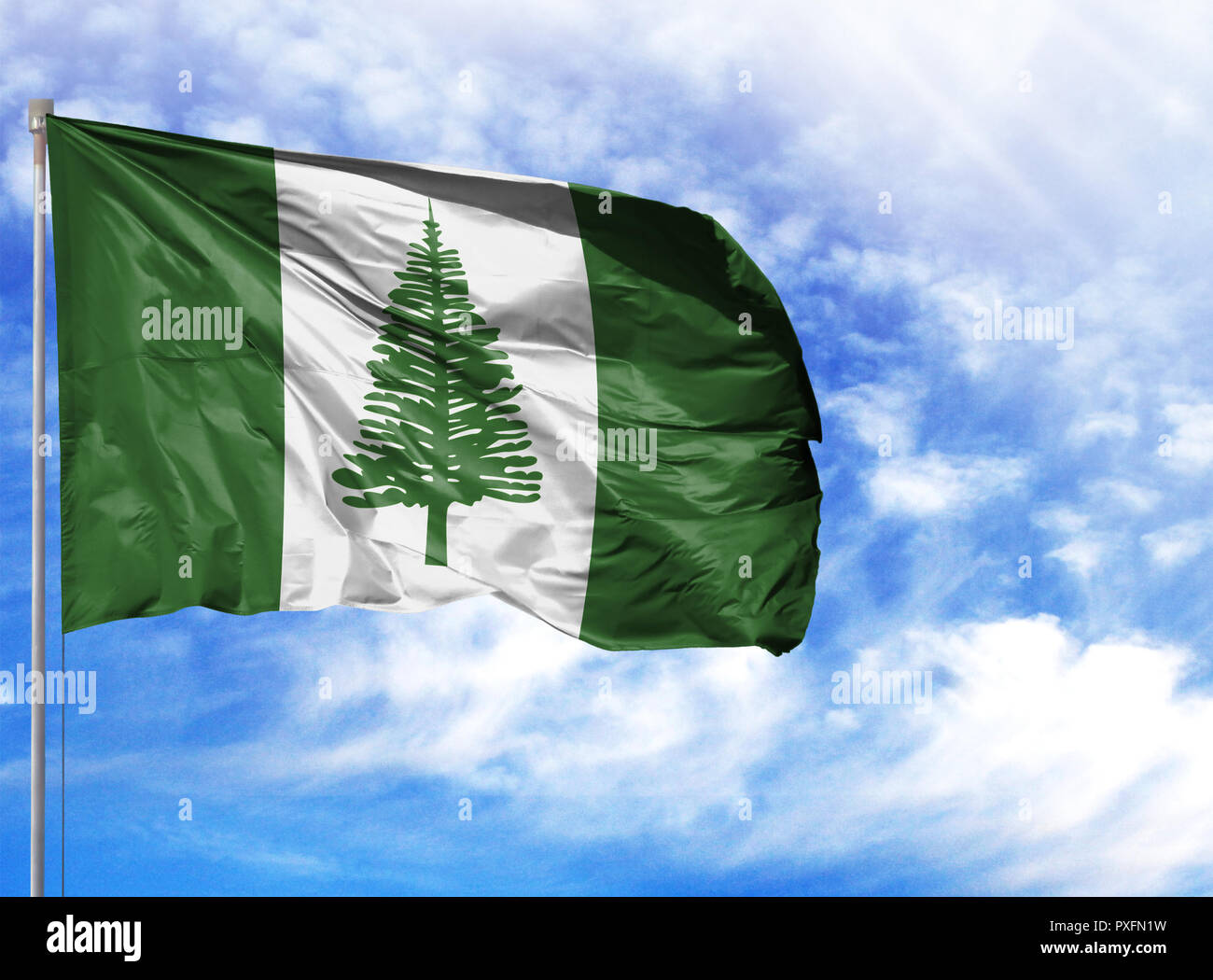 National flag of Norfolk Island on a flagpole in front of blue sky