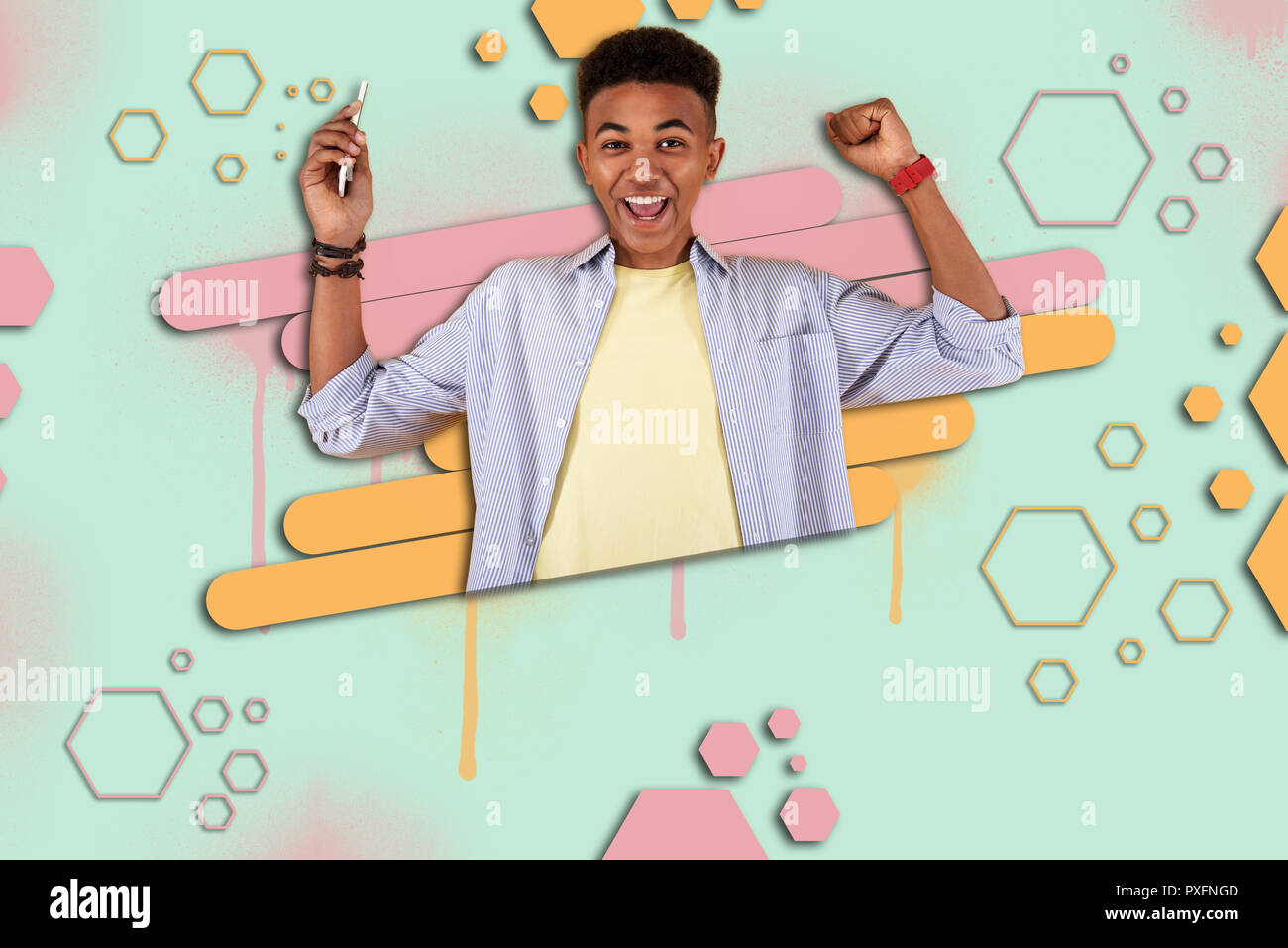 Happy mulatto boy feeling extremely cheerful after winning prize in online game Stock Photo