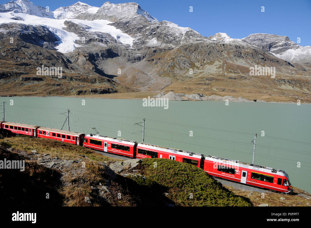 Swiss Alps: Train trip over Bernina Pass and Lake Bianco in the upper Engadin in canton Graubünden Stock Photo
